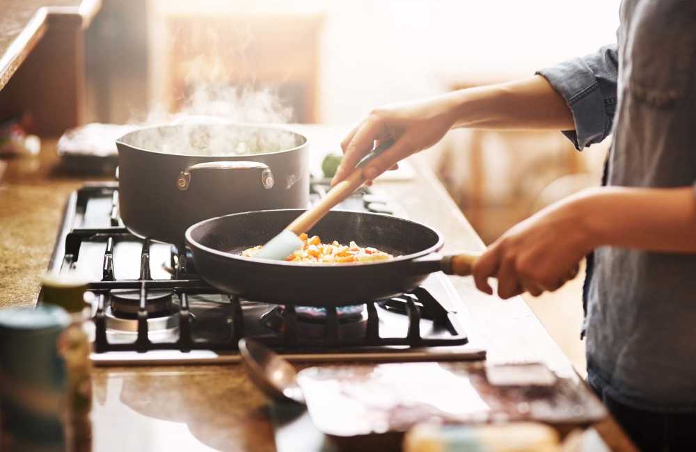 Resident cooking food in the kitchen at Winchester Run in Oklahoma City, Oklahoma