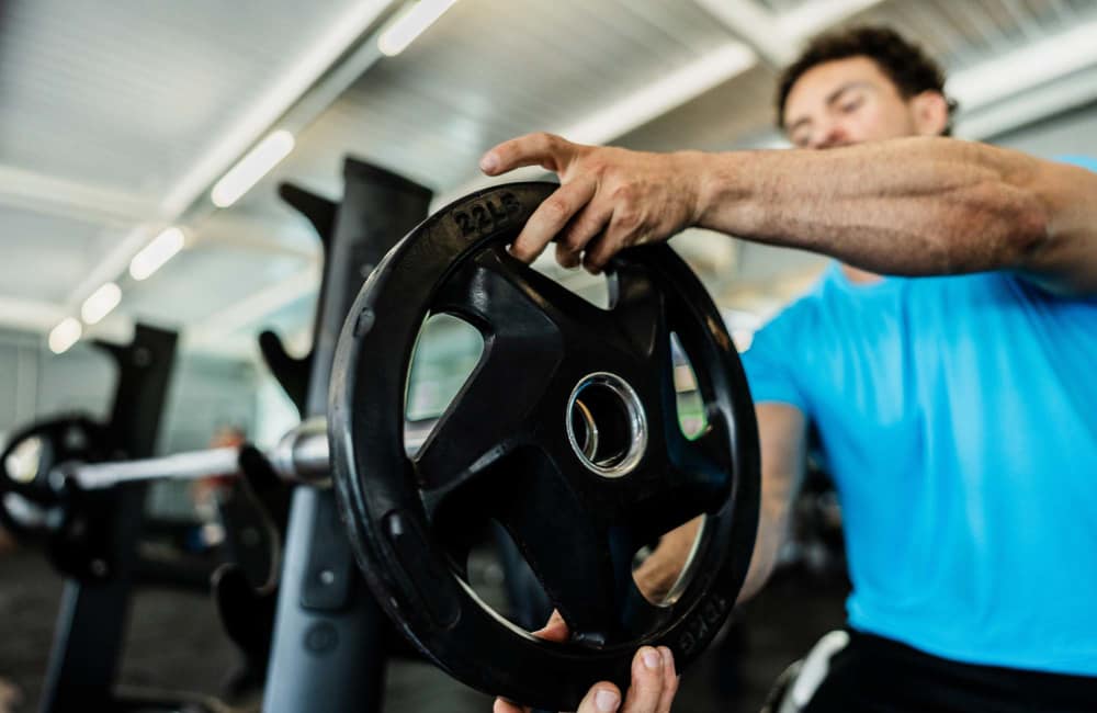 Resident working out in the fitness center with various equipment at Mansions at Riverside in Tulsa, Oklahoma