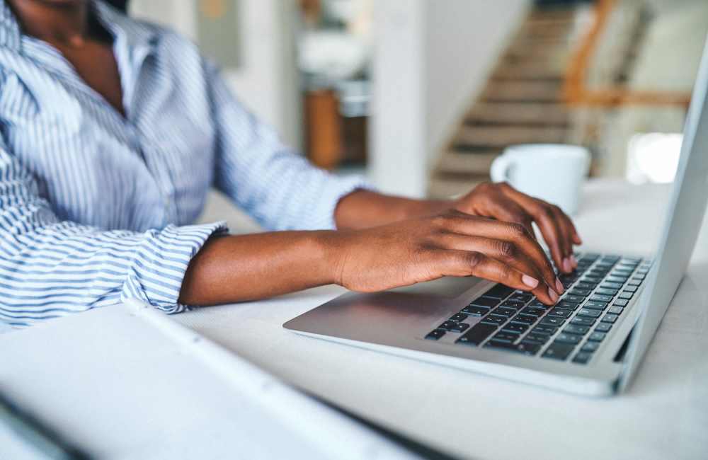 Resident working in laptop at Larkspur Village Apartments in Durant, Oklahoma