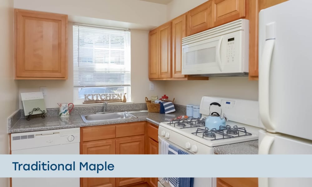 Traditional kitchen with maple cabinetry at Nieuw Amsterdam Apartment Homes in Marlton, New Jersey