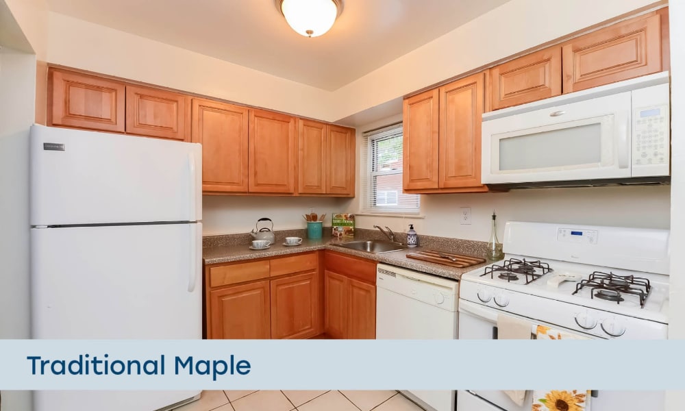 Kitchen with traditional maple cabinetry at Mt. Arlington Gardens Apartment Homes in Mt. Arlington, New Jersey