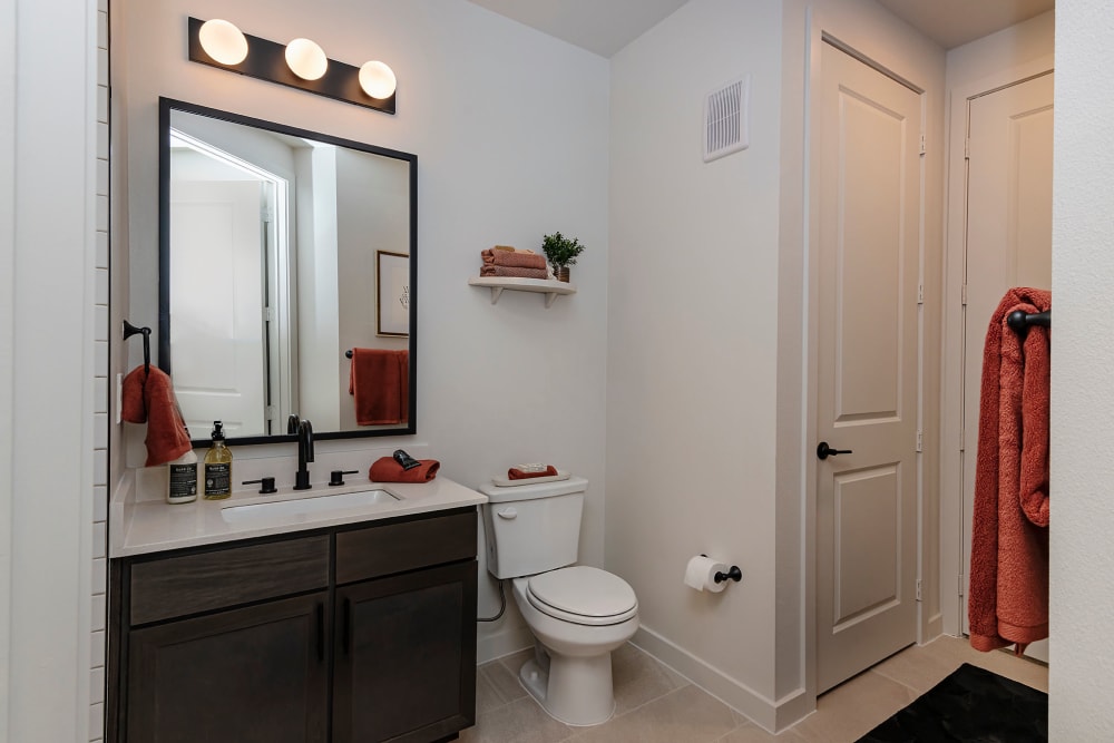 White themed comfort room with vanity mirror at Auro Crossing in Austin, Texas