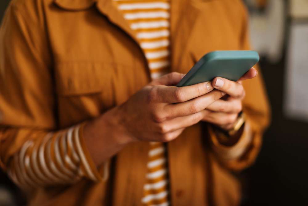 A resident using his phone to make online payments at Smallwood Gardens in Waldorf, Maryland
