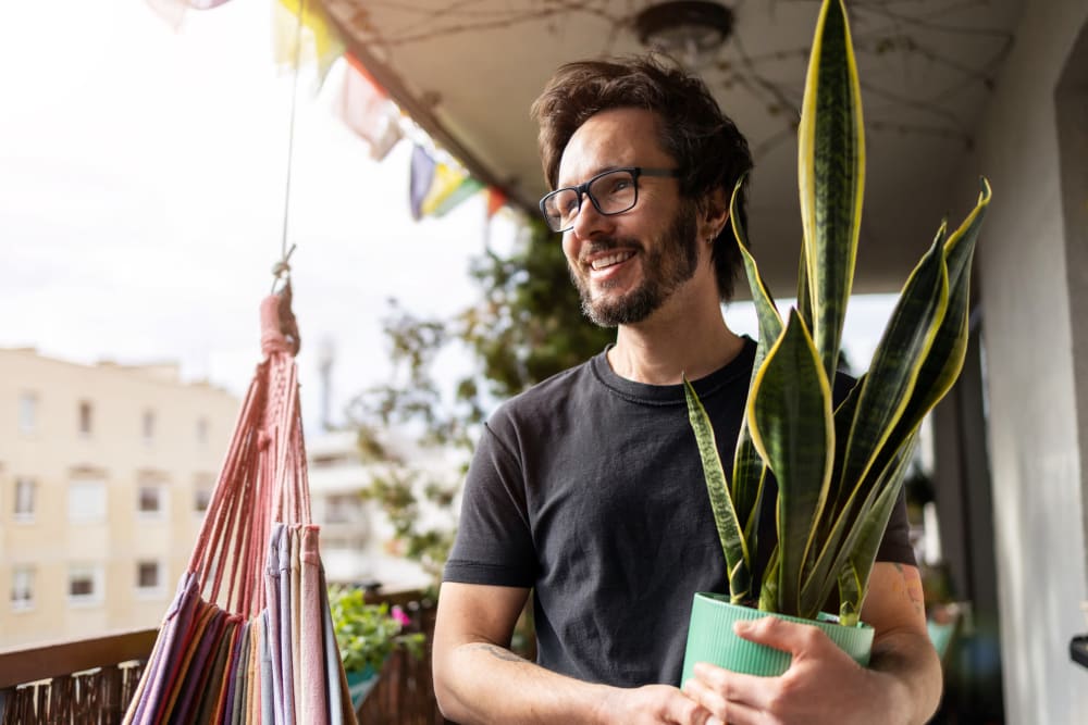 Resident carrying a plant at Brittwood Apartments in Columbus, Georgia