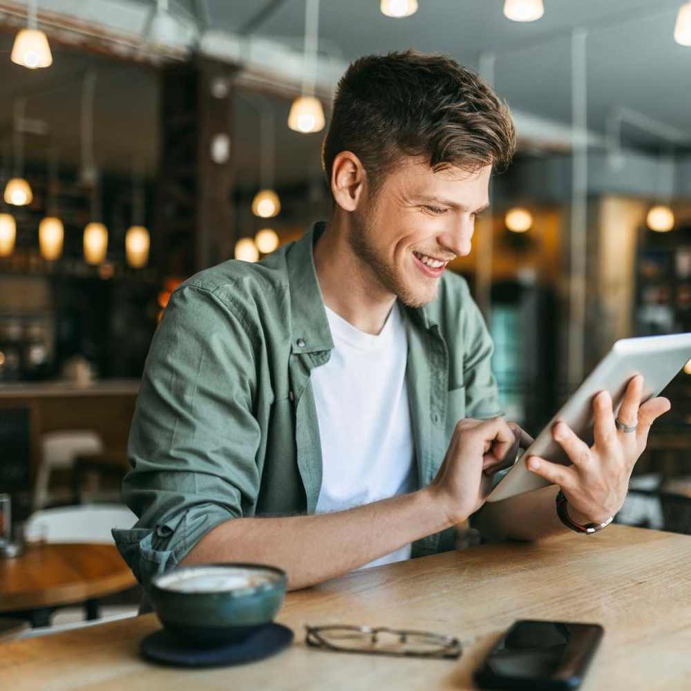 Resident using his tab near Cypress Creek Montfort Drive in Dallas, Texas
