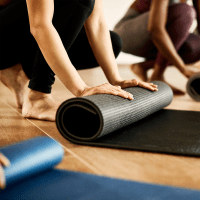 resident rolling up a yoga mat at Clark-Whitehill Enterprises, Inc. in Virginia Beach, Virginia