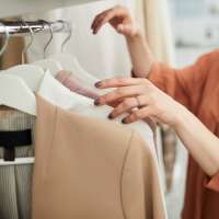 A woman shopping for shirts near Woodchase Apartments in San Leandro, California