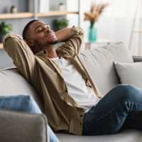 Resident relaxing in his apartment at The Linc in Rochester, New York