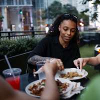 Friends enjoying a meal outdoors near WaterWalk Huntsville in Huntsville, Alabama