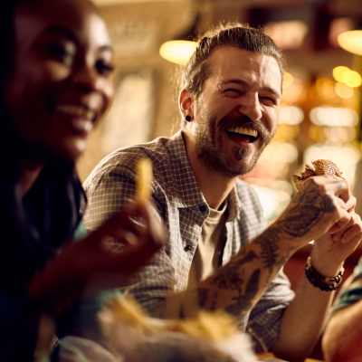 Residents having food at a restaurant near Woodmere Apartments of Venice in Venice, Florida