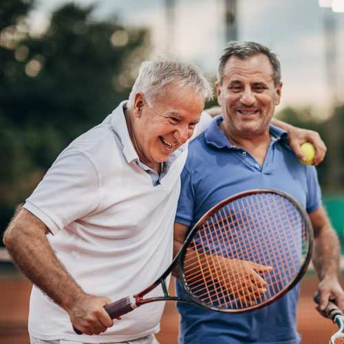 Senior residents playing tennis at Greer Mill Residences in Greer, South Carolina 