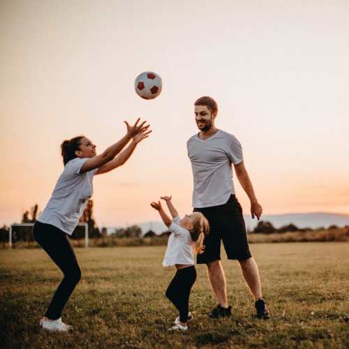 Family playing soccer at Dublin, California near Cotton Wood Apartments