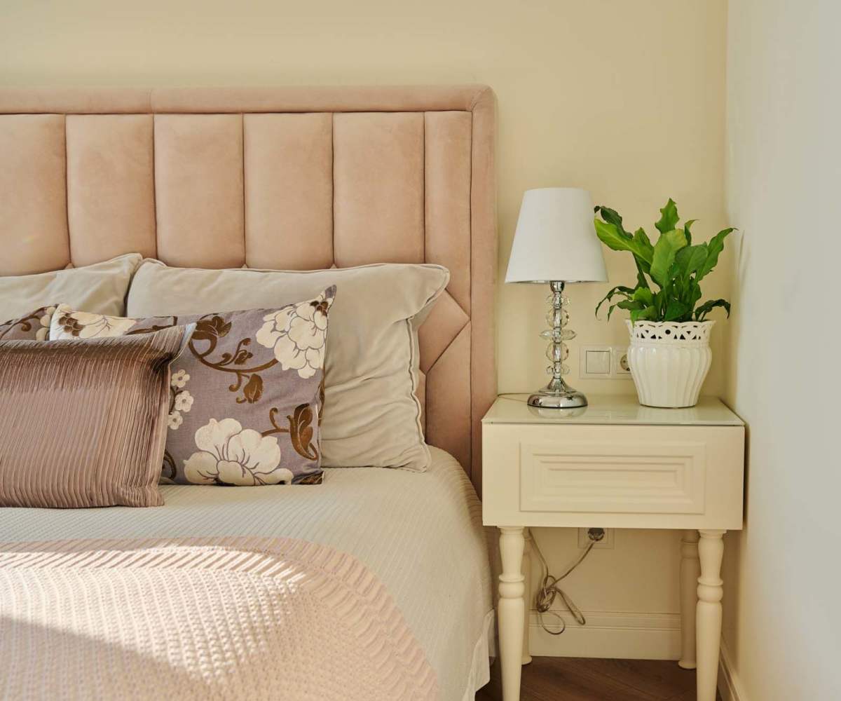 A comfy  bed with side table at Cordova Estates in Florida City, Florida