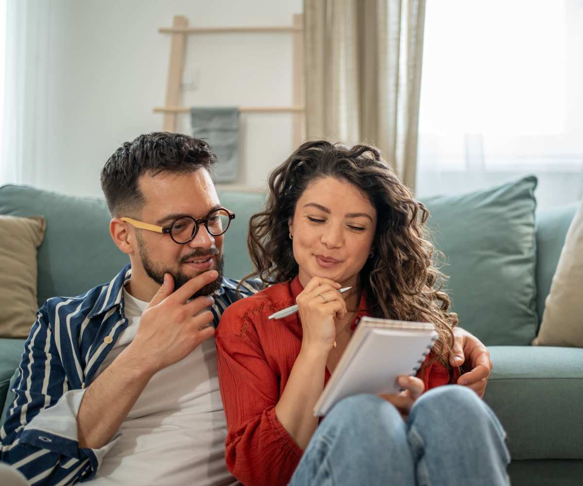 Resident couple sitting in the living room of their apartment home Cross Town Corners in Springfield, Massachusetts