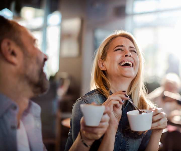 Residents sharing a laugh while sipping coffee at a cafe near Pine View in La Pine, Oregon