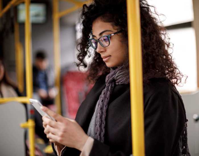 Woman in bus checking her phone at Milepost 5 in Portland, Oregon