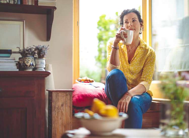 Resident having coffee in her spacious living room at 3371 Washington in Jamaica Plain, Massachusetts