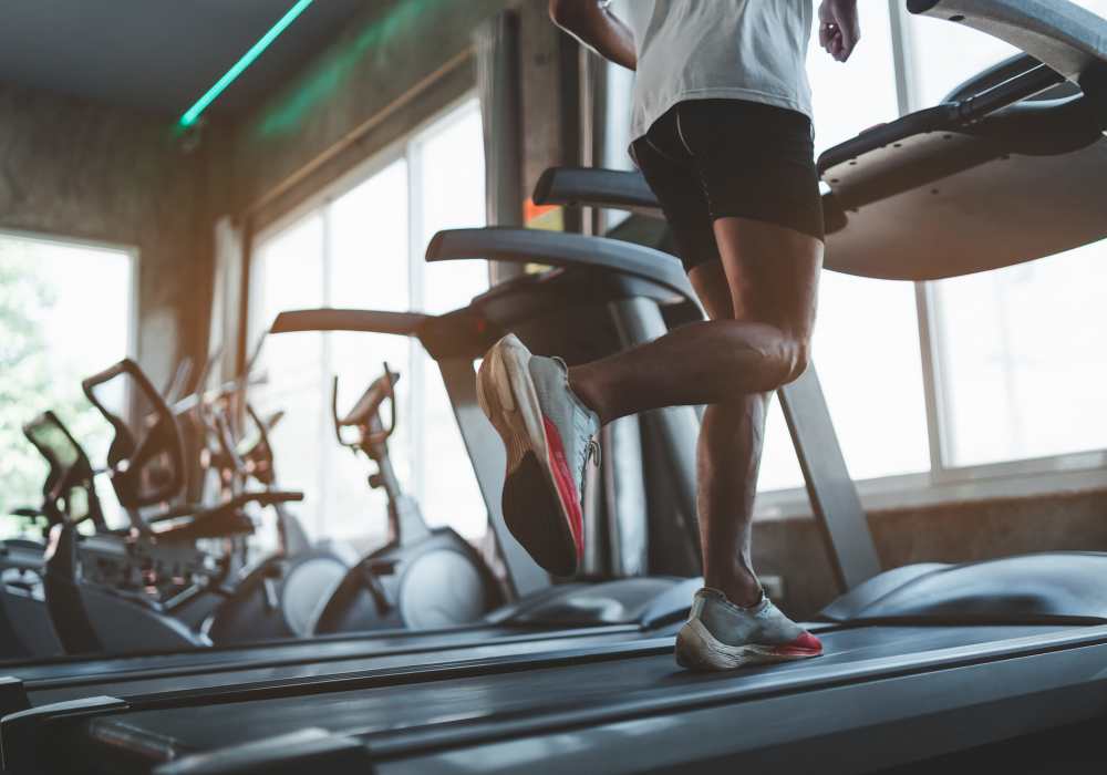 Resident working out on a treadmill in the gym at Andanté in Seattle, Washington