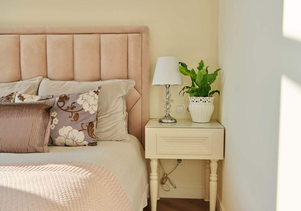 Bed in a furnished bedroom at Cresta Bella in San Diego, California