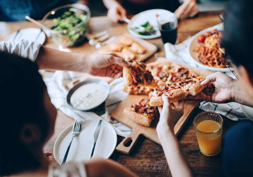 Friends having pizza near Rivers Edge in Lake Elsinore, California