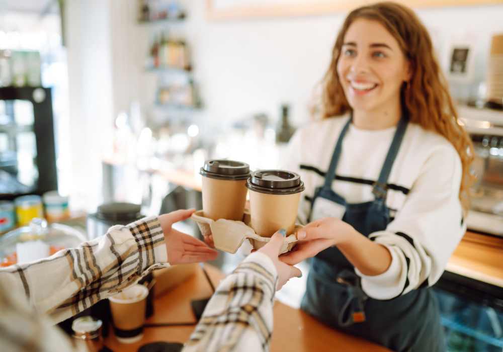 Barista serving two cups of coffe in a coffee shop near Broadway Crossing Apartments in Merrillville, Indiana