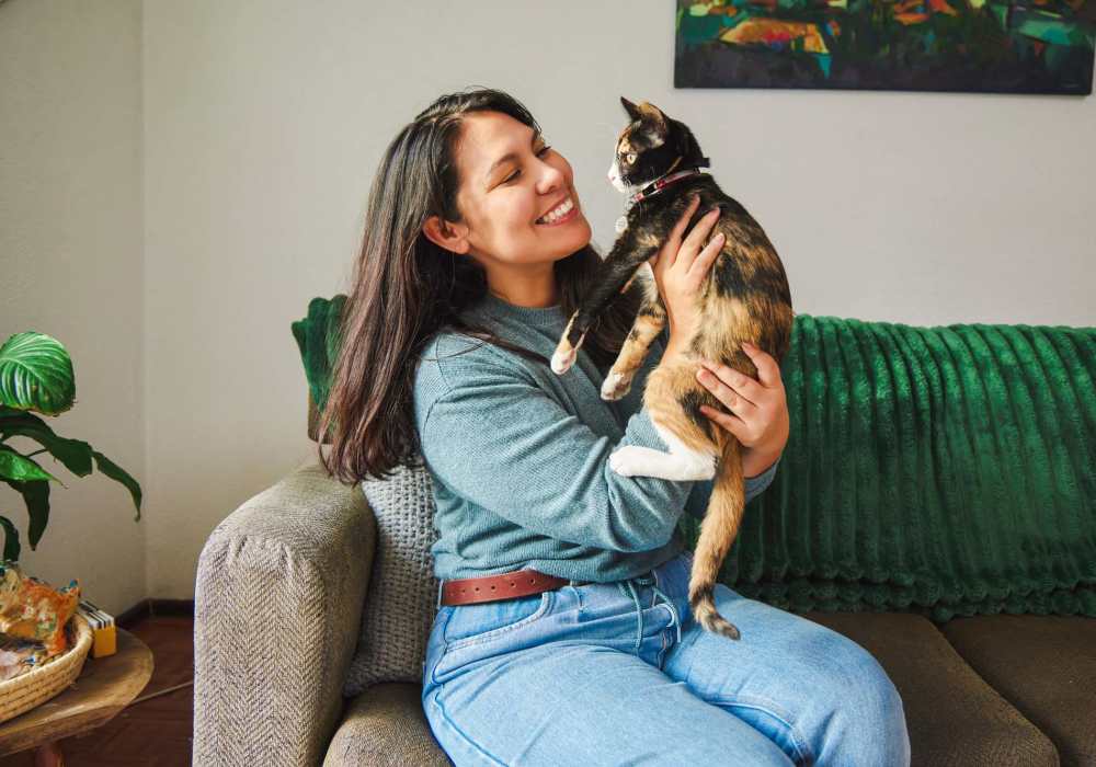 Resident hugging her cat in their pet-friendly home at Heritage Park Apartments & Townhomes in Webster, New York
