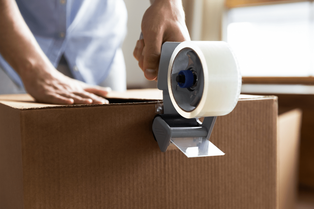 Sealing a box with packing tape at A-American Self Storage in Lancaster, California