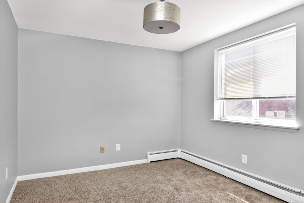 Open bedroom with plush carpeting at The Mark at Carriage West in Hartford, Connecticut