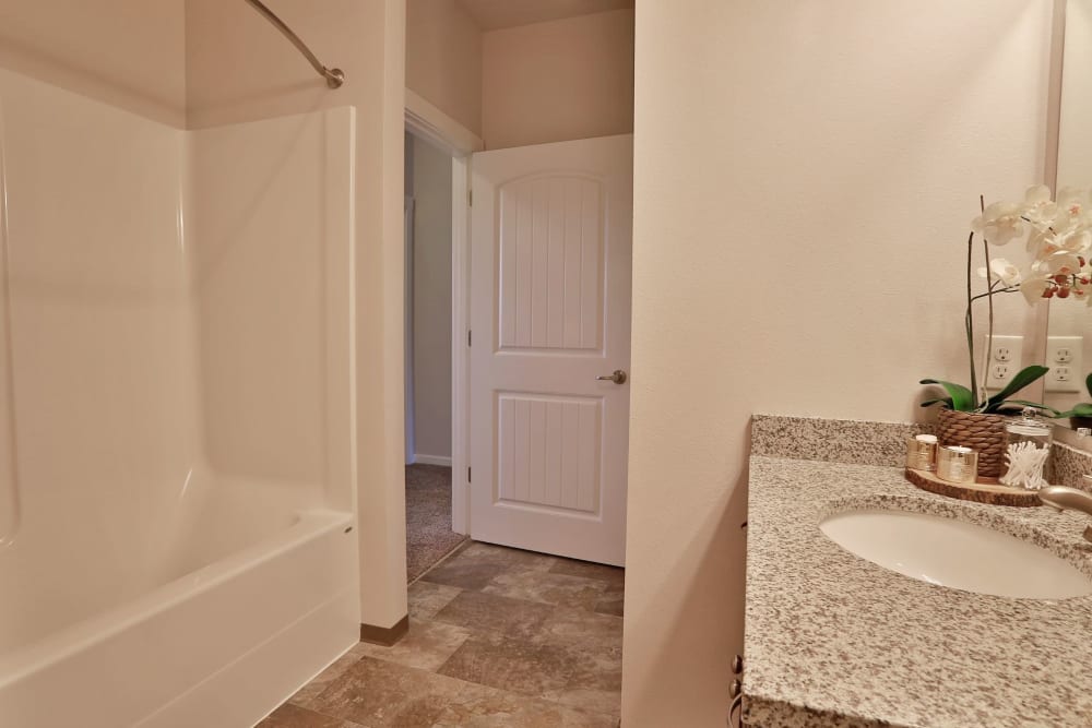 Bright bathroom with luxurious countertops at The Fairway Apartments in Salem, Oregon