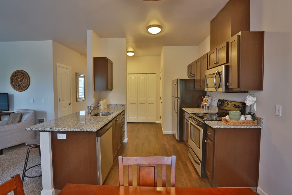 View of the kitchen from the dining table at The Fairway Apartments in Salem, Oregon
