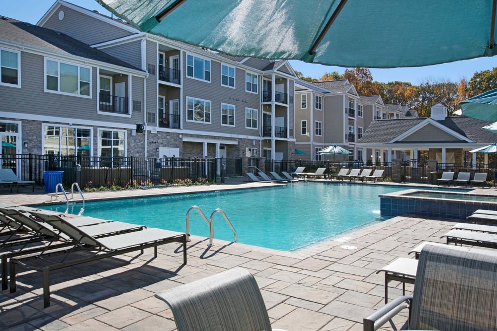On-site swimming pool with lounge chairs at Parc at Roxbury in Roxbury Township, New Jersey