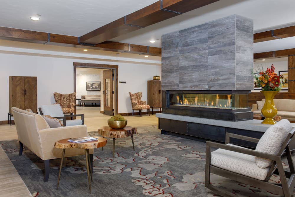 Lounge area with fireplace at Touchmark at Pilot Butte in Bend, Oregon