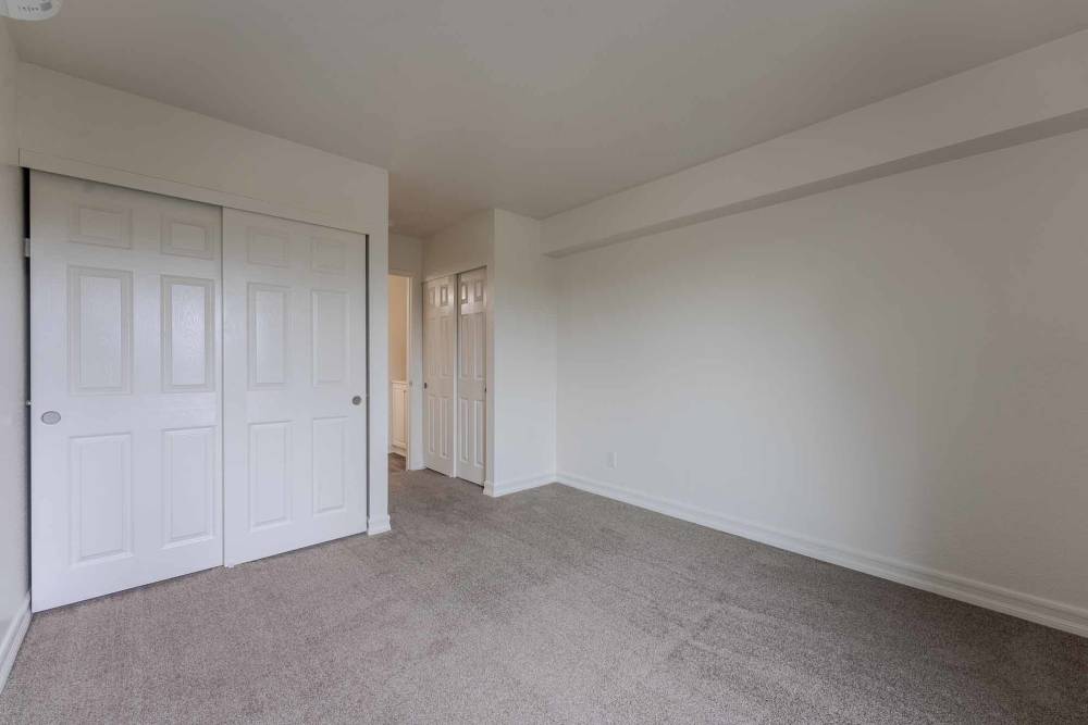 A bedroom with carpet at Beech St. Knolls in San Diego, California