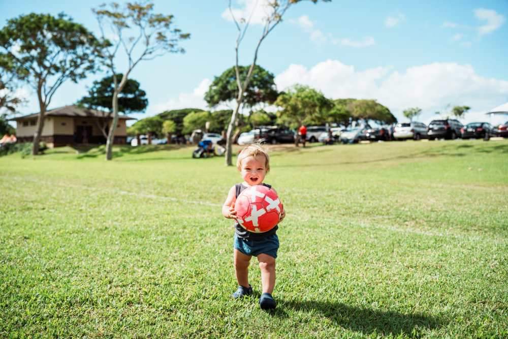 Kids with ball at park near Nalu Waipouli in Kapaa, Hawaii
