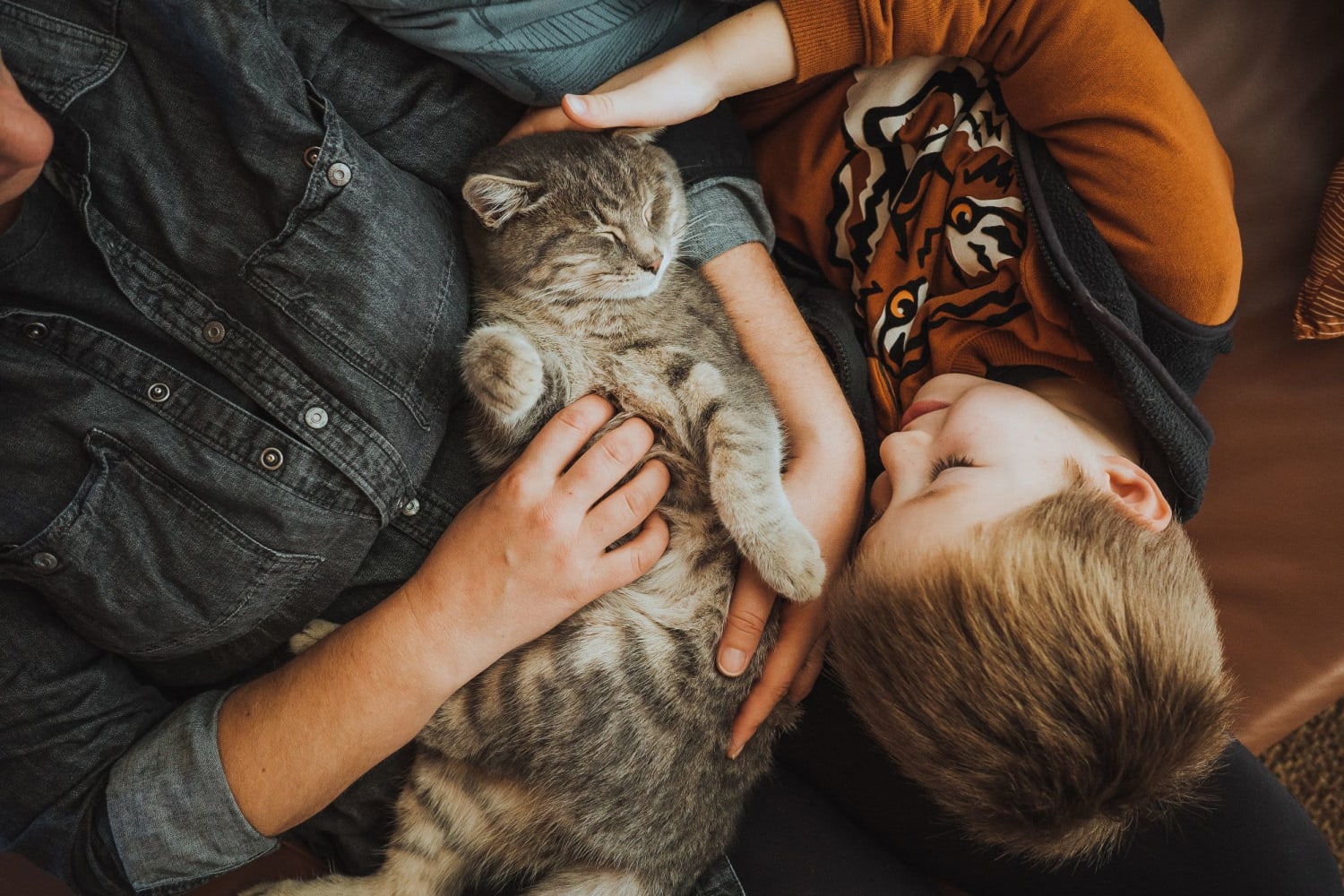 Resident parent and kid cuddling their cat at The Warner in Round Rock, Texas