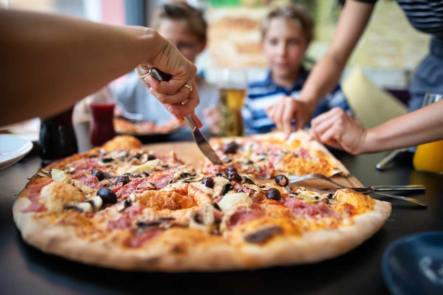 Residents eating pizza in their apartment at Rich Park Apartments in Raleigh, North Carolina