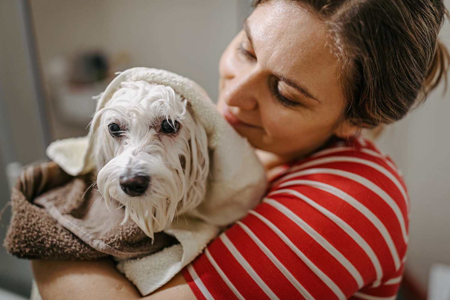 Resident holding her dog in their apartment at Country Lane in Angleton, Texas
