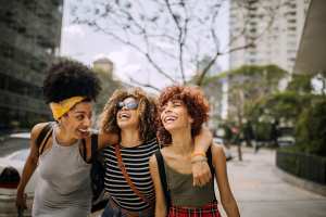 Residents women laughing and smiling on the sidewalk at Copper River in Spokane, Washington