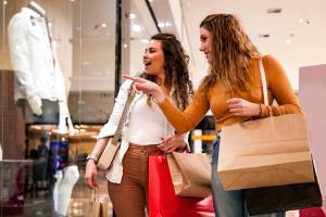 Two women browsing through clothing racks in a store at Andanté in Seattle, Washington