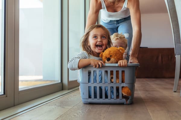 Playing in a laundry basket at Sycamore Commons Apartments in Fremont, California