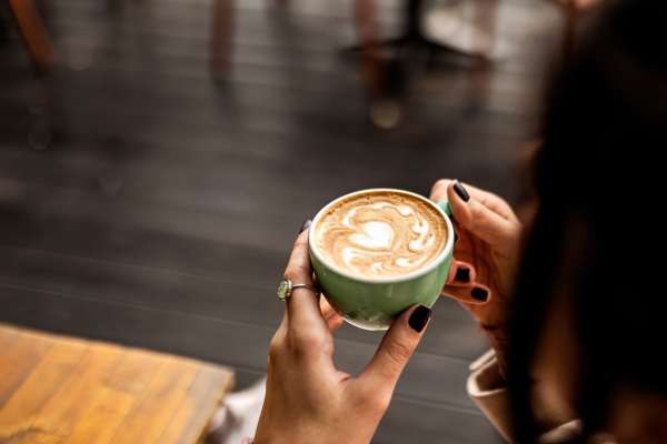 Resident drinking coffee near Delta View Apartments in Antioch, California