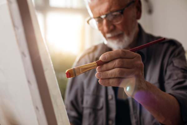 Senior resident painting at Willow Creek Apartments in Escanaba, Michigan
