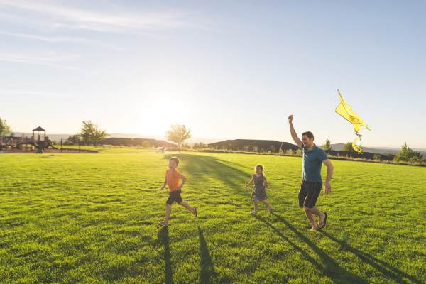 Person running with a yellow flag near Pritchard Park Place in Racine, Wisconsin
