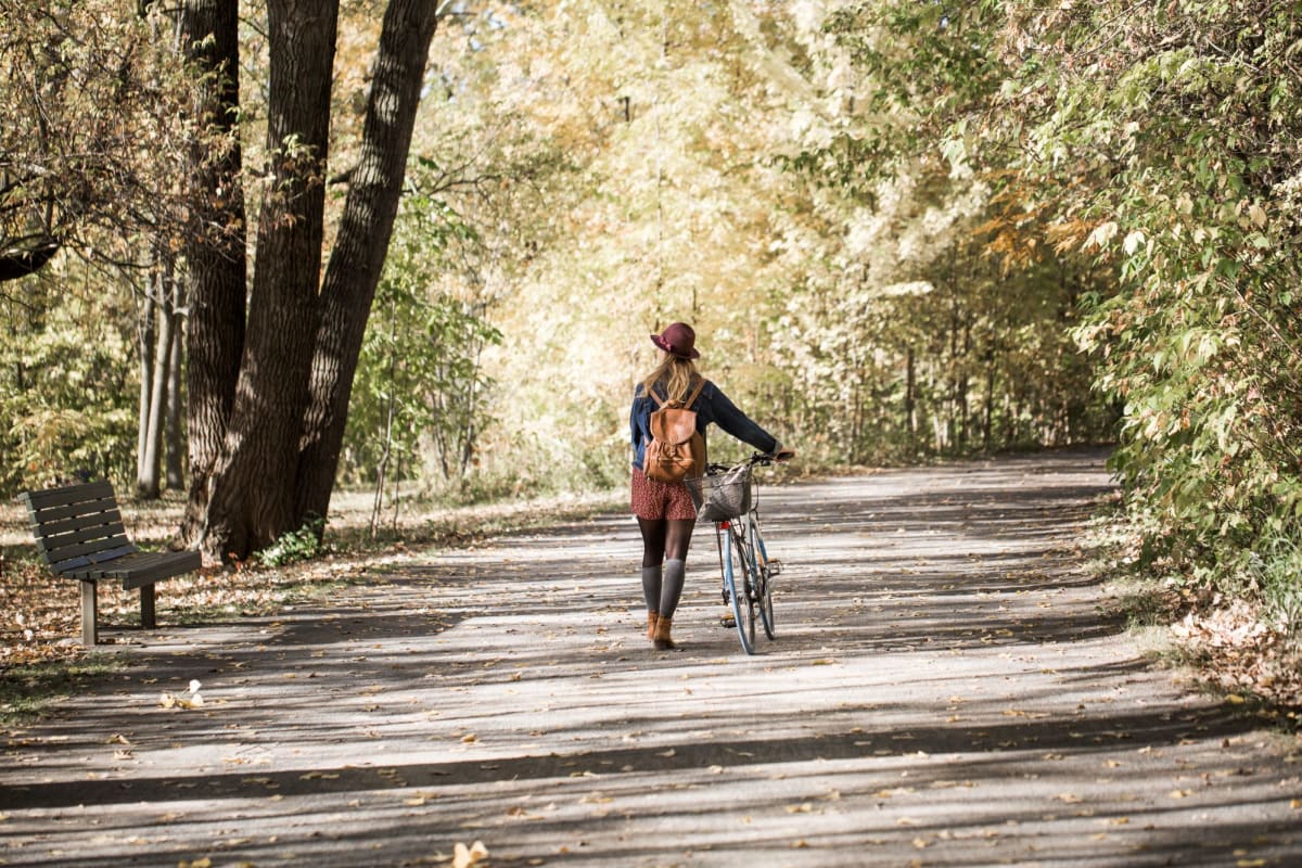 Resident walking with her bike near Reserve at South Coast in Santa Ana, California