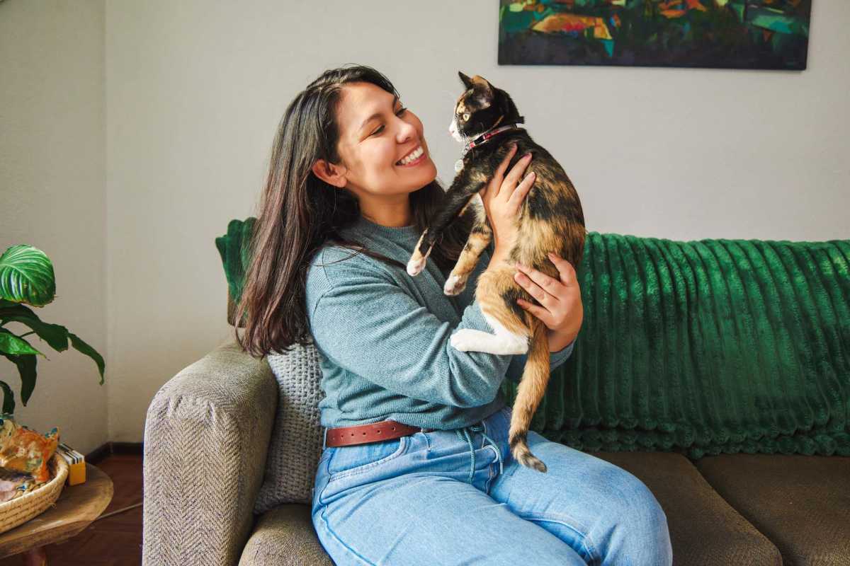 Resident with her pet in living room at Carson Landing in Center Point, Alabama 