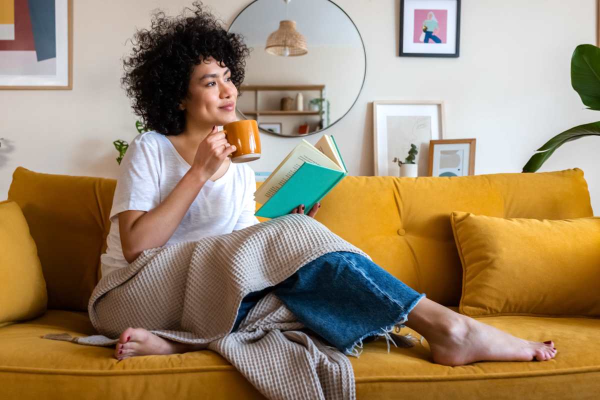 Resident having coffee in living room at Eagles Landing in Memphis, Tennessee