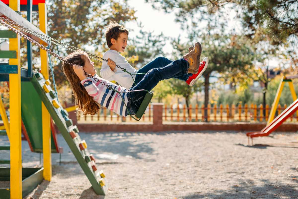 Children swinging on playground swings near The Towns at Patuxent Overlook in Lexington Park, Maryland 