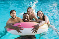 Friends swimming in the pool at Lake House in Los Angeles, California