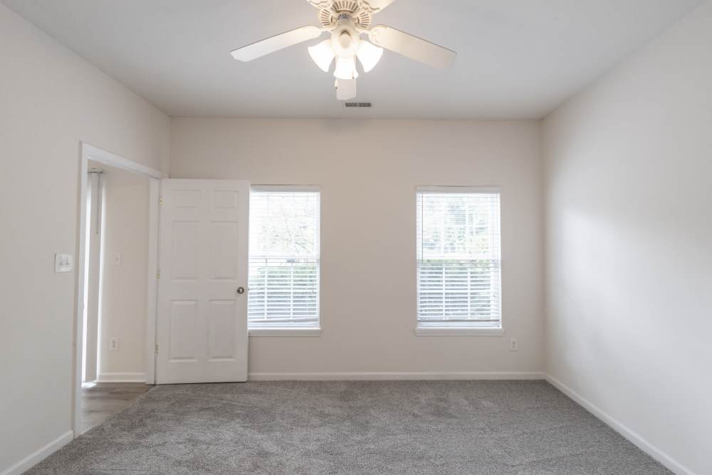 Well-lit bedroom with ceiling fan, large window at Forest Ridge in Bloomington, Indiana, 