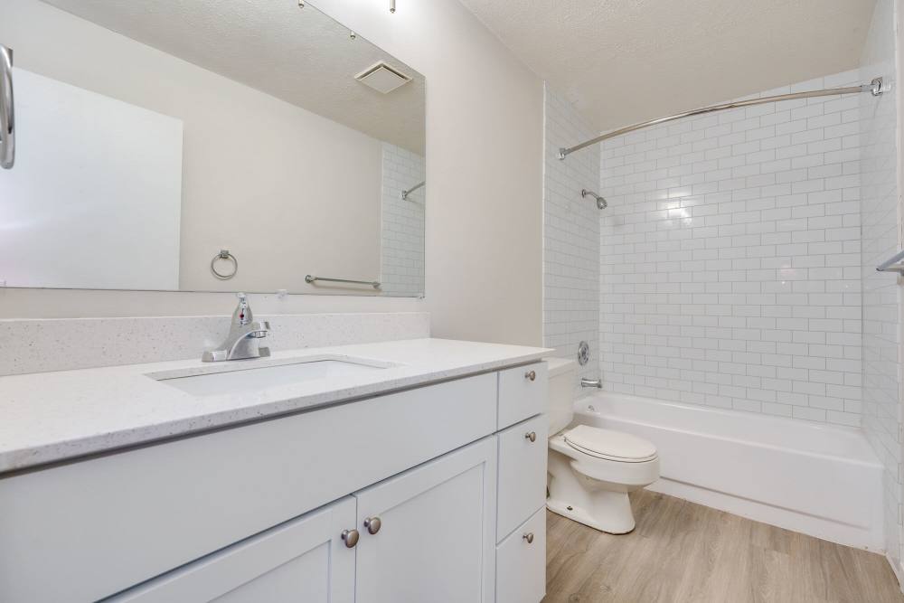 Bright bathroom with mirror and storage space at Maple Oaks in Middletown, Ohio